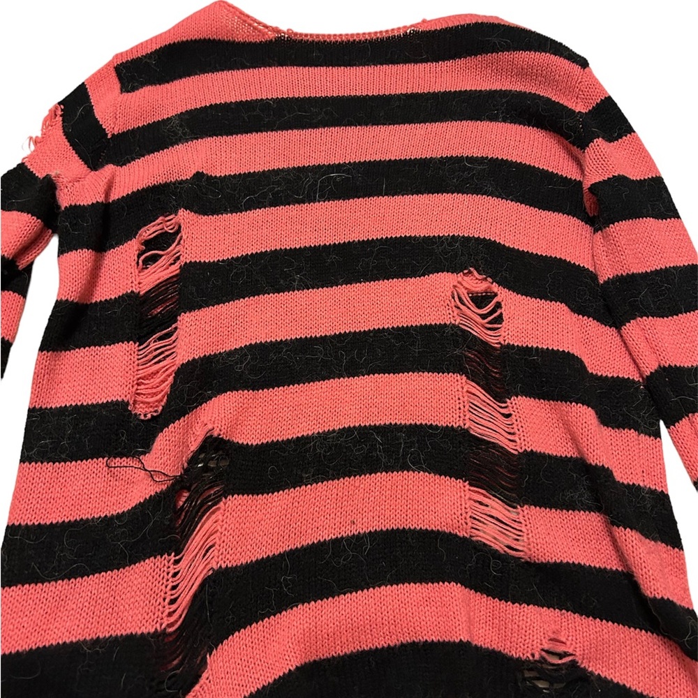 pink and black distressed sweater